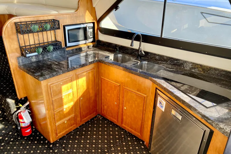 Slide: The Image of Luxurious kitchen in 2001 SportsCat 44 yacht with granite countertops and modern appliances. - 53