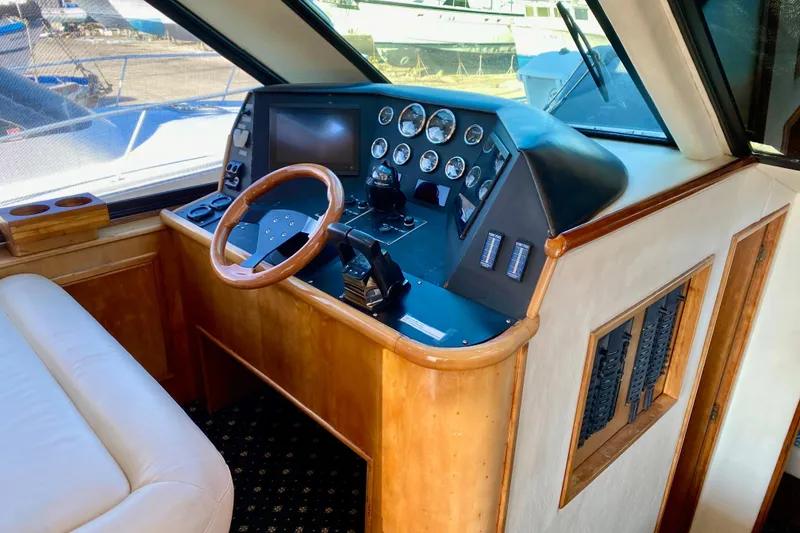Slide: The Image of Luxurious 2001 SportsCat 44 yacht cockpit with wooden steering wheel and control panel. - 55