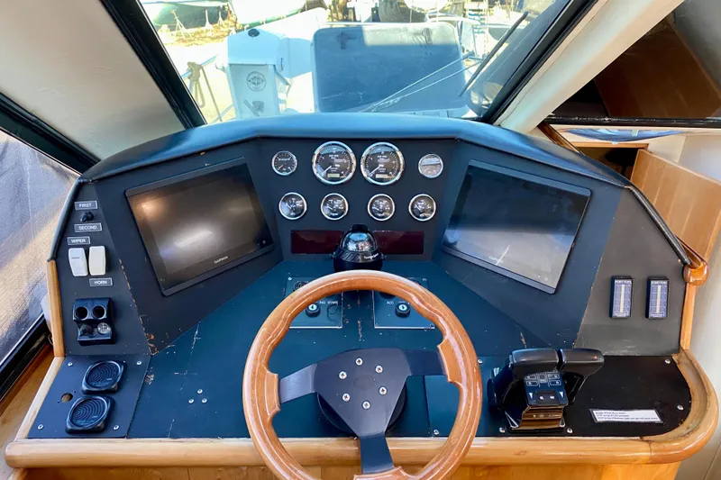 Slide: The Image of Cockpit of 2001 SportsCat 44 boat with steering wheel and navigation controls. - 58
