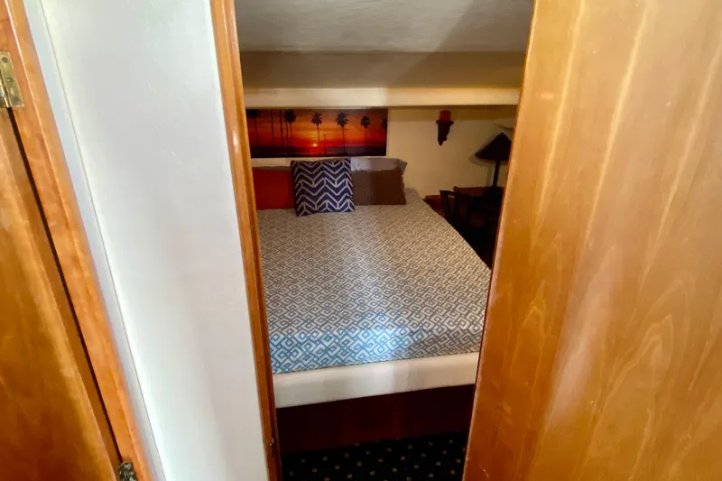Slide: The Image of Cozy bedroom in 2001 SportsCat 44 boat with patterned bedding and sunset artwork. - 72