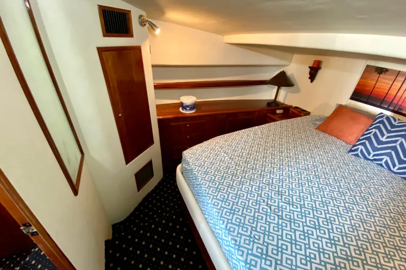 Slide: The Image of Cozy cabin interior of 2001 SportsCat 44 with patterned bedding and wooden accents. - 73