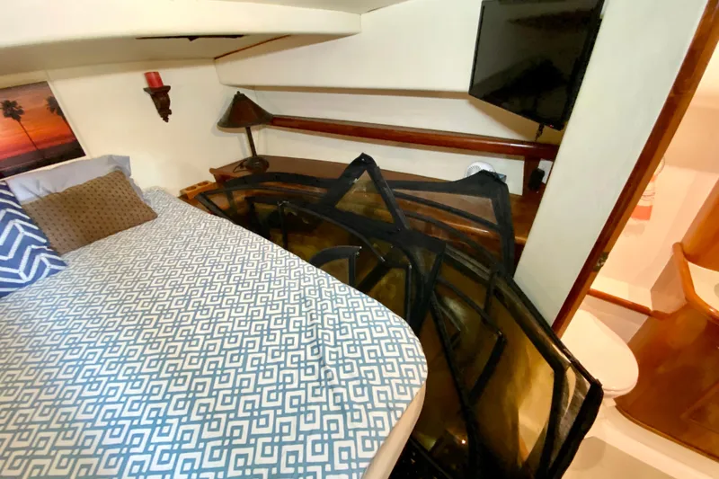 Slide: The Image of Cozy cabin interior of 2001 SportsCat 44 with bed, TV, and decor. - 74