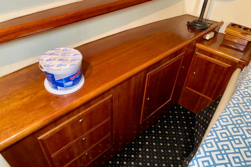 Slide: The Image of Wooden interior of 2001 SportsCat 44 with storage and patterned bedding. - 76