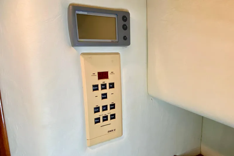 Slide: The Image of Control panel and display in a 2001 SportsCat 44 boat interior. - 81