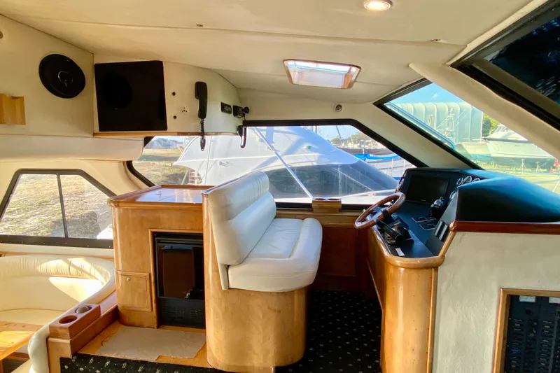 Slide: The Image of Interior of a 2001 SportsCat 44 yacht with luxurious seating and control panel. - 86