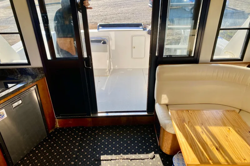 Slide: The Image of Interior of a 2001 SportsCat 44 boat with seating and table. - 87