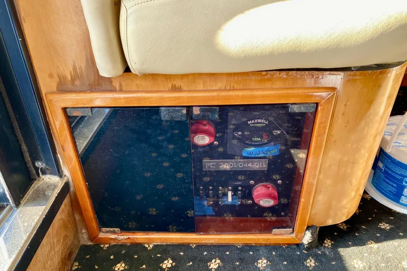 Slide: The Image of Control panel of a 2001 SportsCat 44 boat, featuring switches and dials. - 89