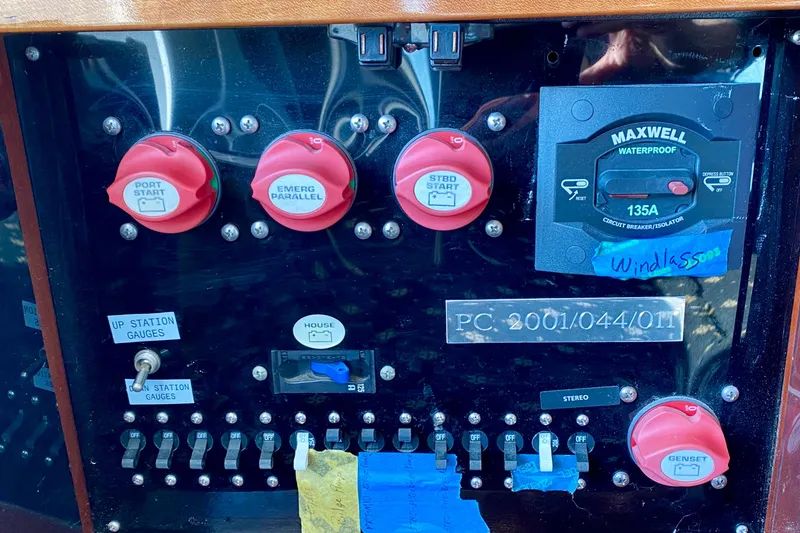 Slide: The Image of Control panel of a 2001 SportsCat 44 with switches and circuit breakers. - 90