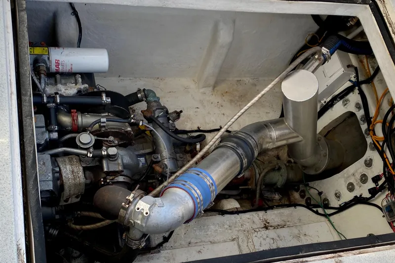 Slide: The Image of Engine compartment of a 2001 SportsCat 44, showcasing mechanical components and piping. - 92