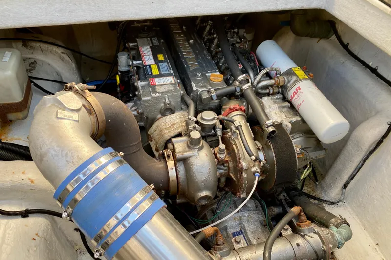 Slide: The Image of Engine compartment of a 2001 SportsCat 44, showcasing mechanical components and piping. - 93