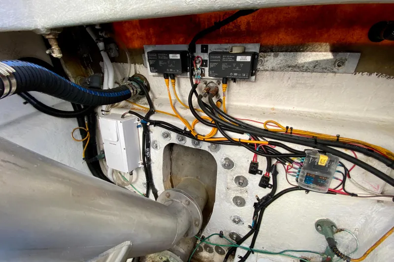 Slide: The Image of Engine compartment wiring of a 2001 SportsCat 44 boat, featuring cables and connectors. - 98
