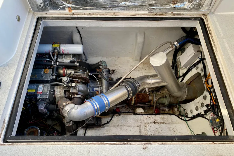 Slide: The Image of Engine compartment of a 2001 SportsCat 44, showcasing mechanical components and piping. - 99