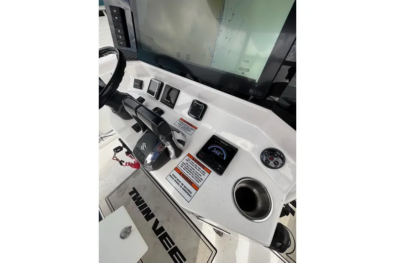 Slide: The Image of 2025 Twin Vee 260 GFX2 CC boat dashboard with navigation screen and controls. - 15