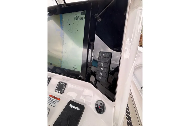 Slide: The Image of 2025 Twin Vee 260 GFX2 CC boat dashboard with navigation display and controls. - 17