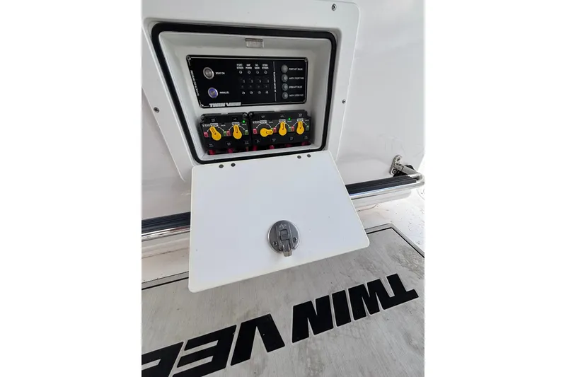 Slide: The Image of Control panel of 2025 Twin Vee 260 GFX2 CC boat, featuring switches and labels. - 19