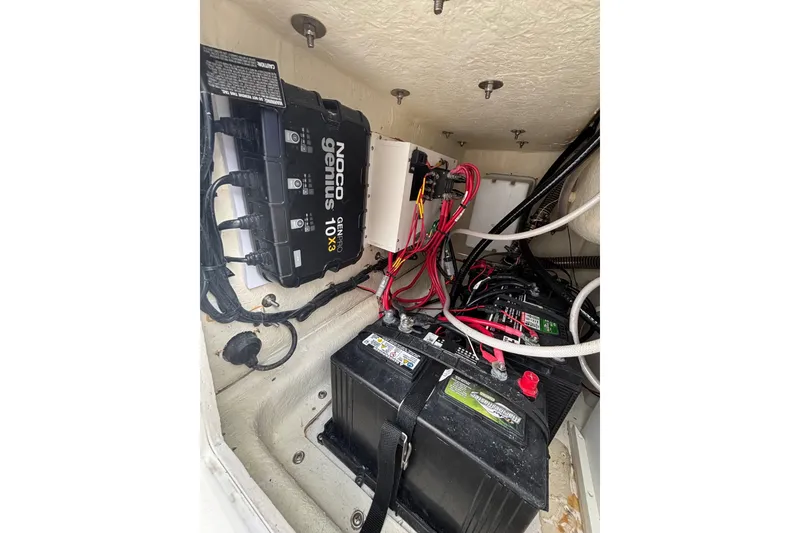 Slide: The Image of Battery compartment of 2025 Twin Vee 260 GFX2 CC with NOCO Genius charger. - 21