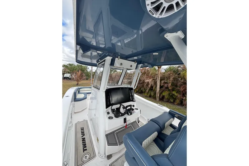 Slide: The Image of 2025 Twin Vee 260 GFX2 CC boat interior with modern console and seating. - 22