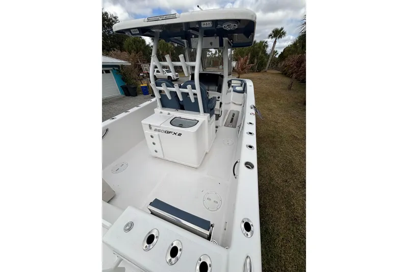 Slide: The Image of 2025 Twin Vee 260 GFX2 CC boat, spacious deck, modern design, outdoor setting. - 24