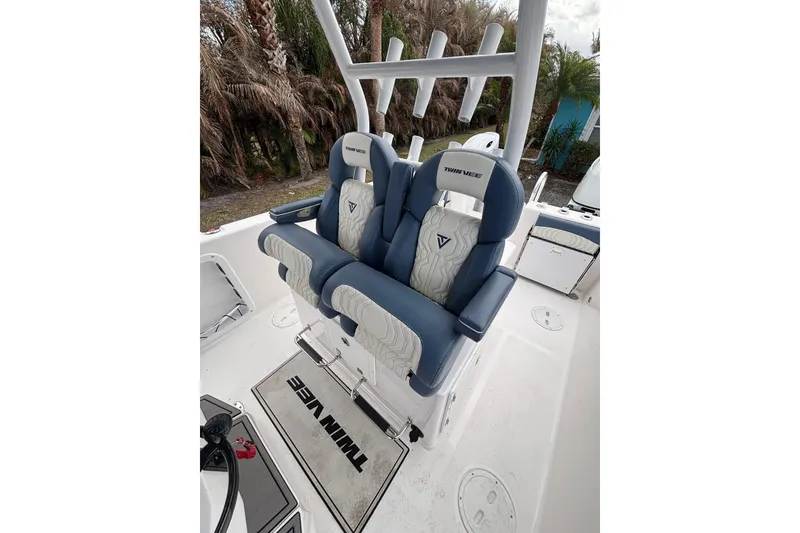 Slide: The Image of 2025 Twin Vee 260 GFX2 CC boat interior with dual blue and white seats. - 28