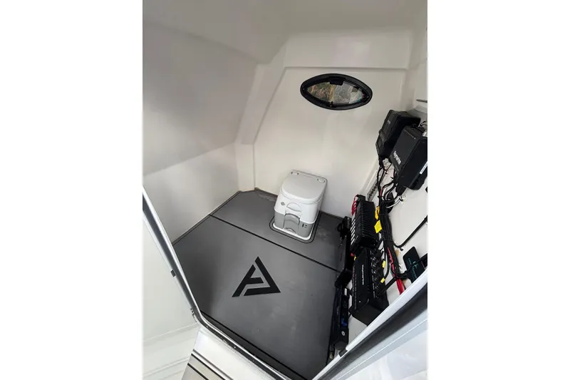 Slide: The Image of Interior of 2025 Twin Vee 260 GFX2 CC boat with compact toilet and equipment. - 33