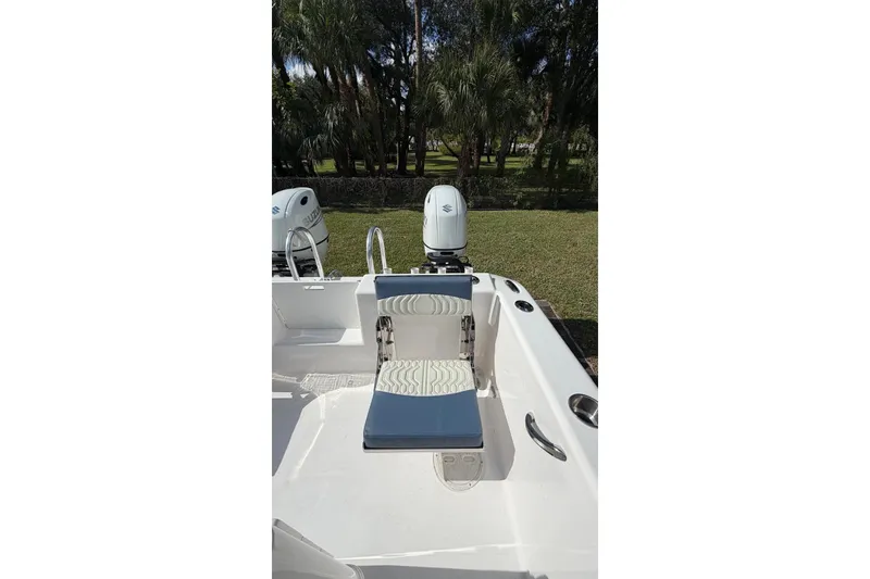 Slide: The Image of 2025 Twin Vee 260 GFX2 CC boat with dual outboard motors and seating. - 4