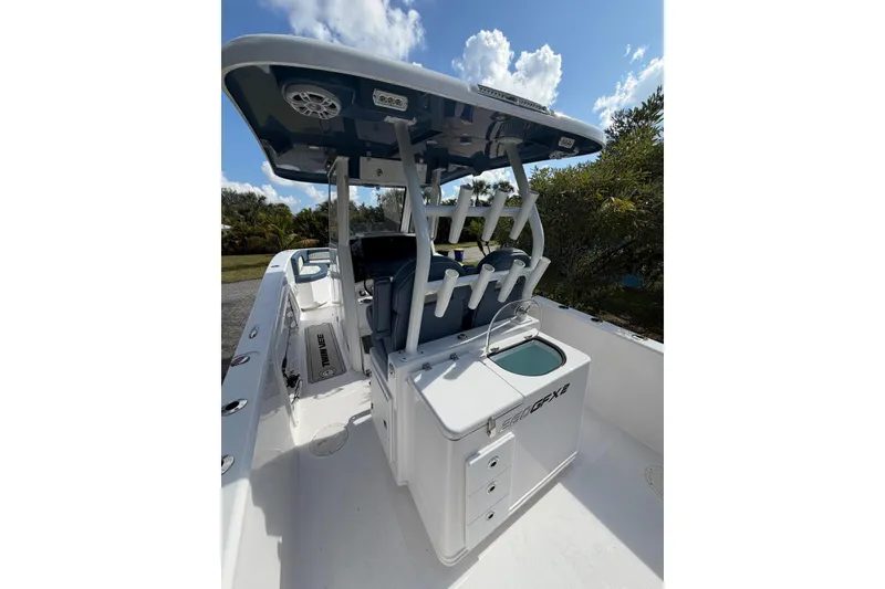 Slide: The Image of 2025 Twin Vee 260 GFX2 CC boat interior with rod holders and storage compartments. - 5