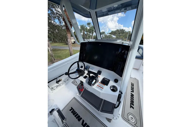 Slide: The Image of 2025 Twin Vee 260 GFX2 CC boat console with steering wheel and navigation display. - 6