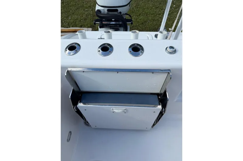 Slide: The Image of 2025 Twin Vee 260 GFX2 CC boat console with rod holders and storage compartment. - 9