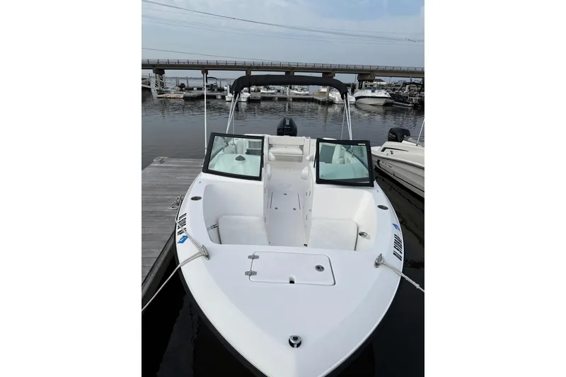 Slide: The Image of 2024 Aquasport 2200 Center Console boat docked at marina, showcasing sleek design. - 3