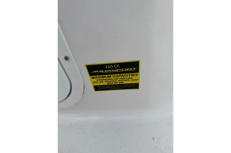 Slide: The Image of 2024 Aquasport 2200 Center Console capacity label, 8 persons, 1600 lbs, max HP 200. - 9