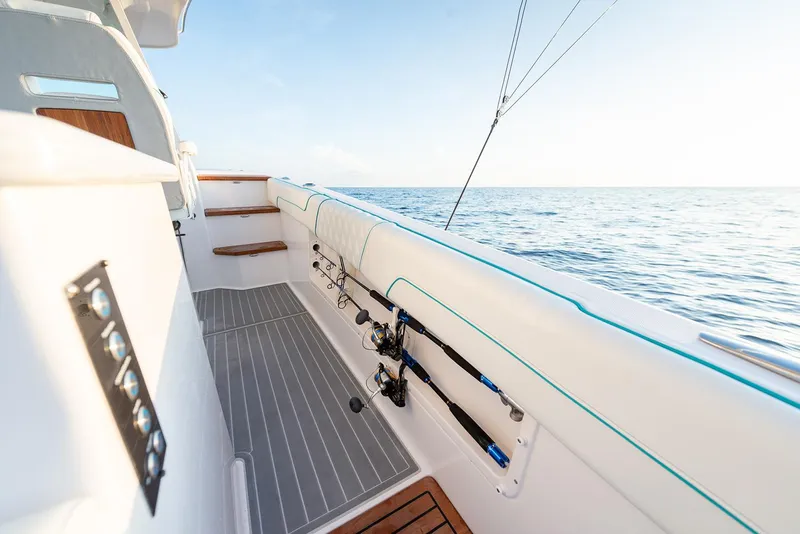 Slide: The Image of Manufacturer Provided Image: 2022 Regal 38 SAV boat deck with fishing rods and ocean view. - 9