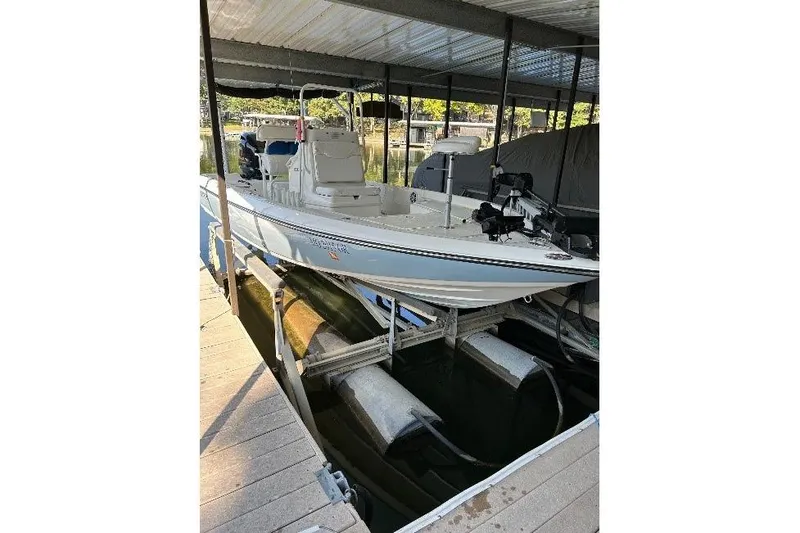 Slide: The Image of 2023 Skeeter SX210 boat docked in a covered marina slip. - 10