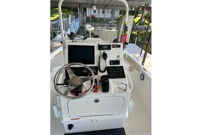 Slide: The Image of 2023 Skeeter SX210 boat console with steering wheel and navigation equipment. - 12