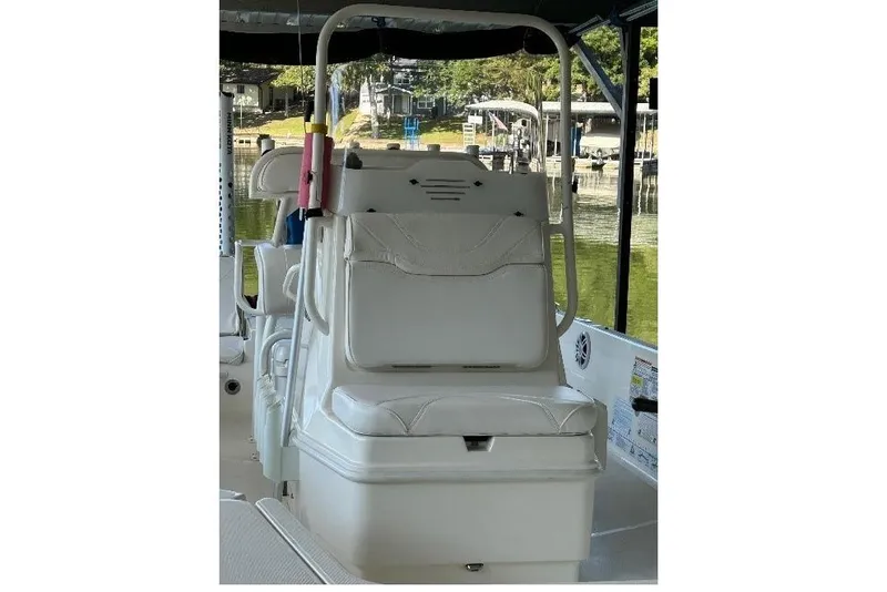 Slide: The Image of 2023 Skeeter SX210 boat interior with white seating and storage compartment. - 13
