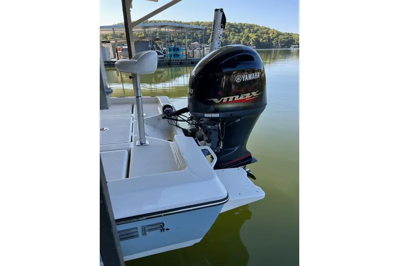 Slide: The Image of 2023 Skeeter SX210 boat with Yamaha VMAX outboard motor on a calm lake. - 19