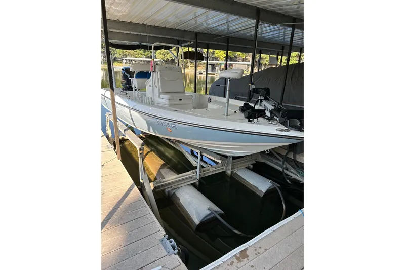 Slide: The Image of 2023 Skeeter SX210 boat docked in a covered marina. - 3