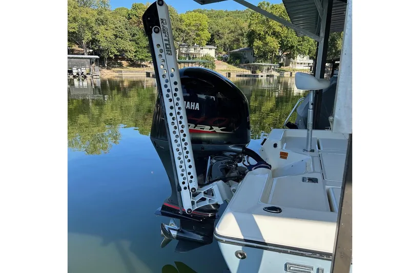 Slide: The Image of 2023 Skeeter SX210 boat with Yamaha outboard motor docked on a calm lake. - 6