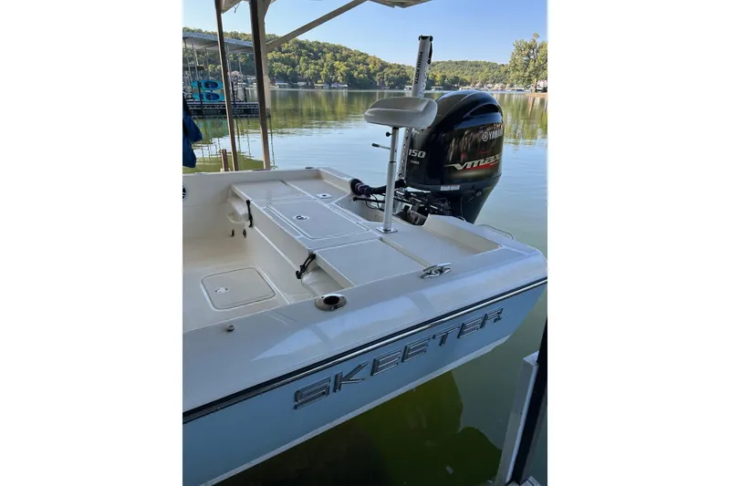 Slide: The Image of 2023 Skeeter SX210 boat with Yamaha VMAX engine docked on a serene lake. - 7