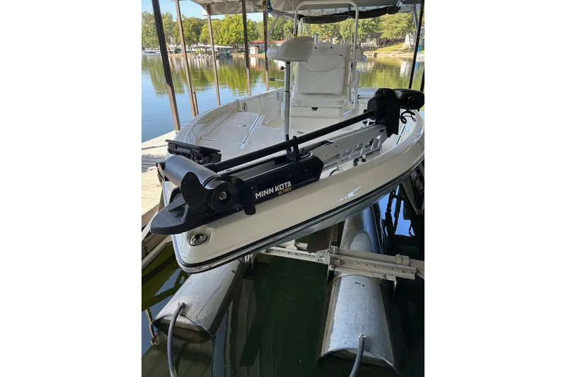 Slide: The Image of 2023 Skeeter SX210 boat with Minn Kota trolling motor docked on a lift. - 8