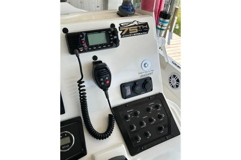 Slide: The Image of Control panel of 2023 Skeeter SX210 boat with radio and switches. - 9
