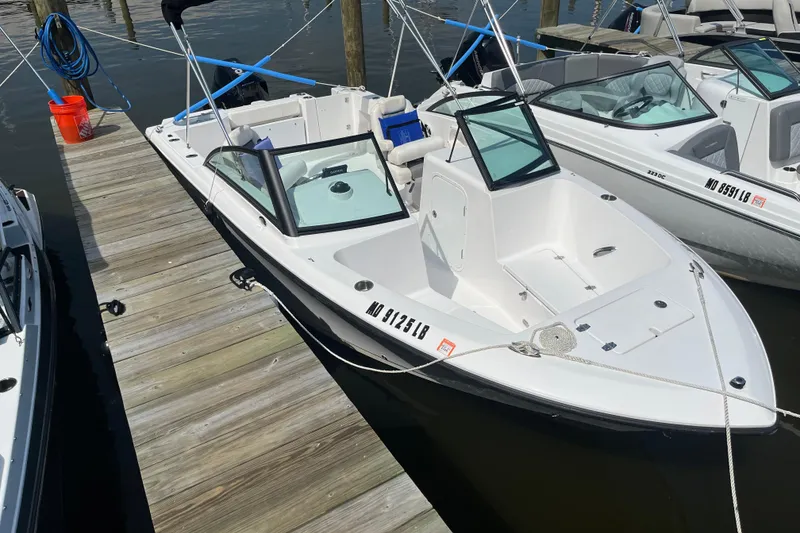The Image of 2024 Aquasport 2200 Dual Console boat docked at marina. - 0