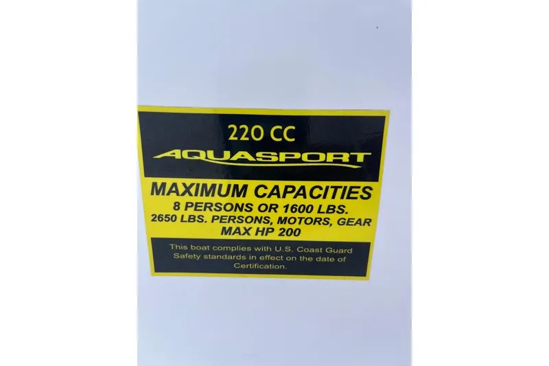 Slide: The Image of 2024 Aquasport 2200 Dual Console capacity label, 8 persons, 2650 lbs, max HP 200. - 10
