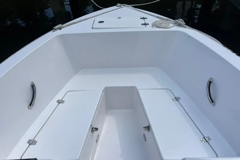 Slide: The Image of 2024 Aquasport 2200 Dual Console boat interior with storage compartments. - 3