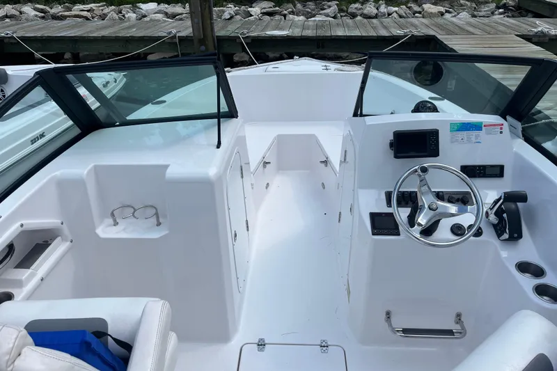 Slide: The Image of 2024 Aquasport 2200 Dual Console boat interior with steering wheel and dashboard. - 5