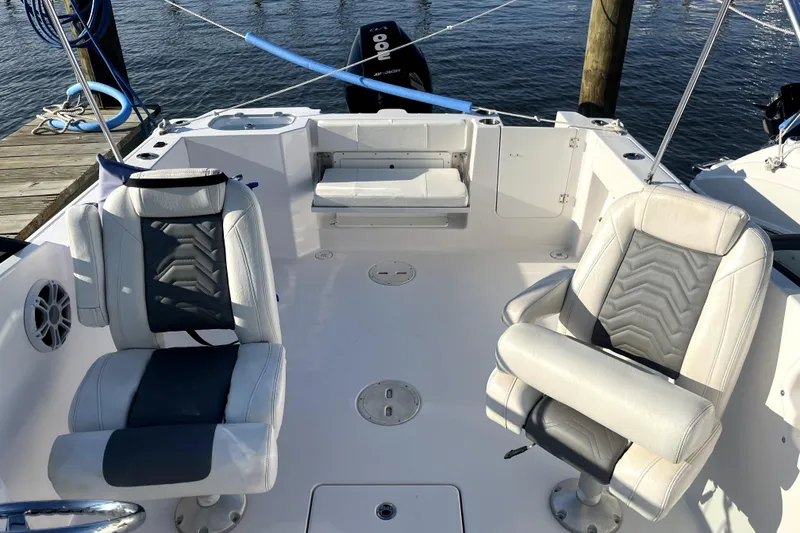 Slide: The Image of 2024 Aquasport 2200 Dual Console boat interior with two cushioned seats. - 7