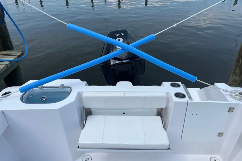 Slide: The Image of 2024 Aquasport 2200 Dual Console boat stern with motor and safety ropes. - 8