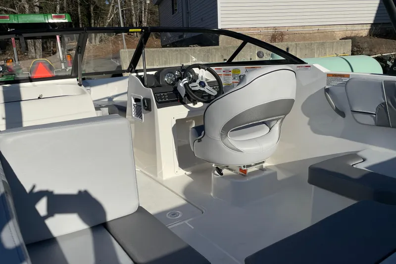 Slide: The Image of 2026 Bayliner VR4 Bowrider OB interior with steering wheel and seating. - 12