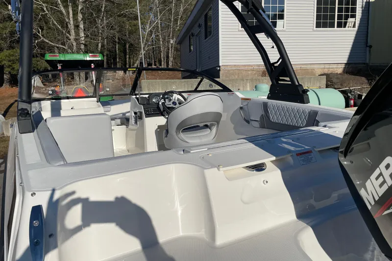 Slide: The Image of 2026 Bayliner VR4 Bowrider OB interior with modern seating and steering wheel. - 13