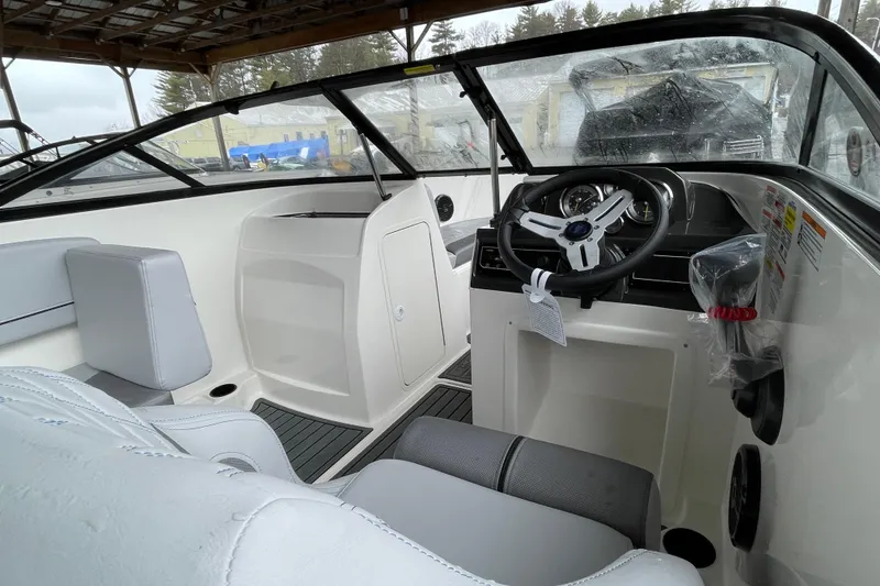 Slide: The Image of 2026 Bayliner VR4 Bowrider OB interior with steering wheel and seating. - 24