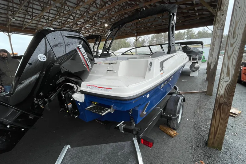 Slide: The Image of 2026 Bayliner VR4 Bowrider OB with Mercury outboard engine under a wooden shelter. - 4